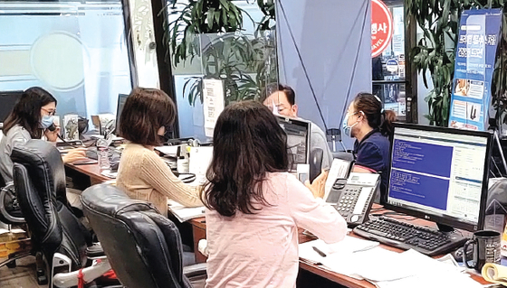 한국 입국자 격리 면제 발표로 LA 한인타운 여행사들에 모국 여행 문의가 급증하고 있다. 지난 11일 항공권 예약 전화와 손님이 이어진 태양여행사. [태양여행사 제공]