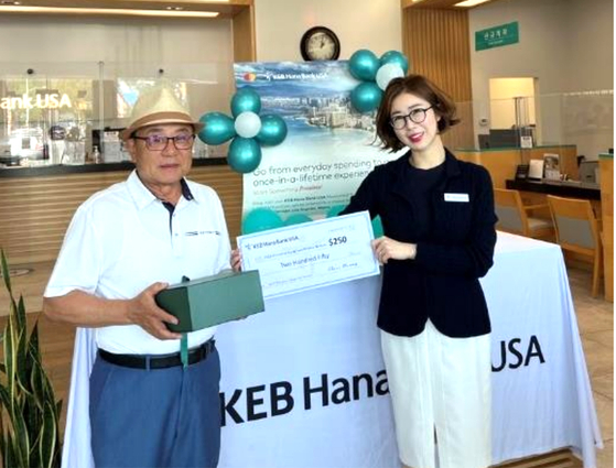 KEB 하나은행 USA(“하나은행”)는 최근 마스터카드와 함께 진행한 Priceless Surprises® 캠페인의 당첨자를 발표하고 플러싱 지점에서 시상식을 진행했다. 한미영 포트리 지점장(오른쪽)이 캠페인 우승자에게 상품을 전달하고 있다. 황창엽 행장은 “하나은행을 신뢰해주시는 고객분과 직접 만나뵙고 감사의 인사를 드릴 수 있어 기쁘다”고 전했다. [KEB 하나은행 USA]