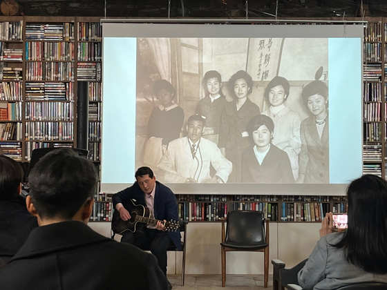 독자와 어머니 사진을 배경으로 아버지가 즐겼던 노래를 부르는 제임스 리. [사진 제임스 리]