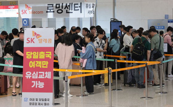 1일 인천국제공항 제1여객터미널 출국장 내 SK텔레콤 로밍센터에서 출국자들이 유심 교체를 위해 줄을 서고 있다. 연합뉴스