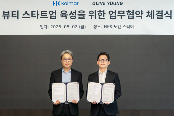 허현행 한국콜마 경영기획본부장(왼쪽)과 장지민 CJ올리브영 경영지원담당이 MOU 행사 중 기념 사진을 찍고 있다. 사진 올리브영