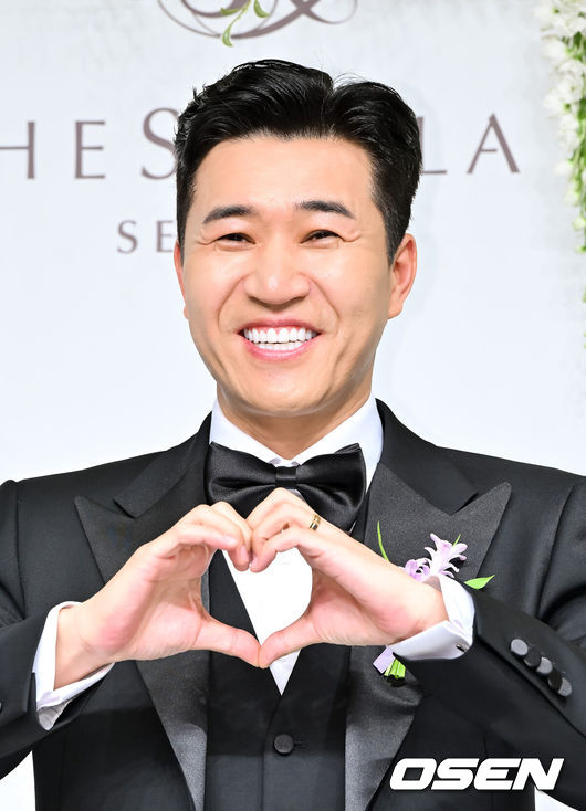 [OSEN=박준형 기자] 가수 김종민은 20일 서울 중구 장충동 신라호텔 영빈관에서 11살 연하 예비 신부와 결혼식을 올린다.예비 신부가 비연예인인 만큼 혼자 포토월에 서는 김종민은 간단한 인터뷰에 응하며 간단한 소감을 전했다. 김종민이 포즈를 취하고 있다.   2025.04.20 / soul1014@osen.co.kr