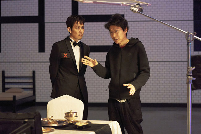 Squid Game S3 (L to R) Lee Jung-jae as Seong Gi-hun, Director Hwang Dong-hyuk in Squid Game S3 Cr. No Ju-han/Netflix  2025