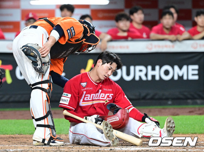 김서현의 몸쪽 빠른 공에 놀라 쓰러진 SSG 안상현과 그의 유니폼에 묻은 흙을 털며 미안함을 전하는 한화 포수 최재훈.