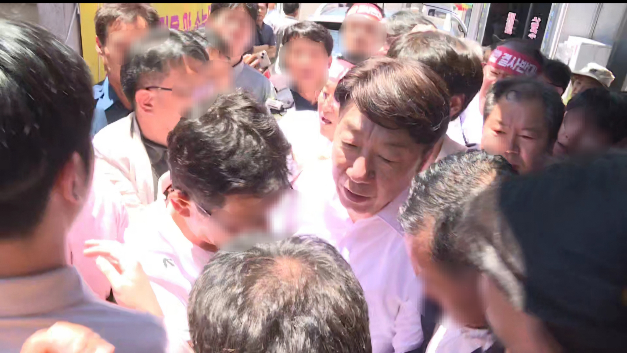 물벼락을 맞은 우범기 전주시장이 앞을 가로막는 통합 반대 측 주민들을 뚫고 관용차로 이동하고 있다. 사진 독자