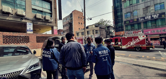 농성 사태가 벌어진 인천 간석3동 고시텔 건물 앞. 임상도 형사를 포함한 보조 협상관, 프로파일러, 수사연구원 교수 등으로 구성된 위기협상팀이 협상 전략을 논의하고 있다. 중앙포토