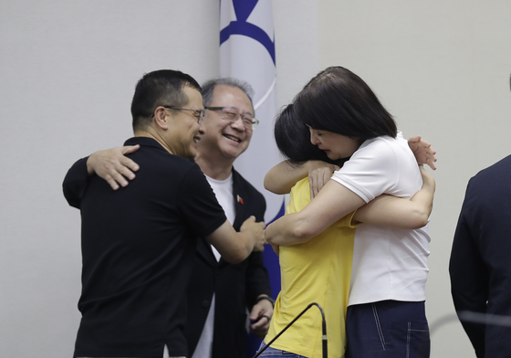 지난달 26일 주민소환(리콜) 투표에서 생환한 입법의원들과 당직자들이 기자회견에 앞서 포옹하며 기뻐하고 있다. AP=연합뉴스