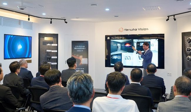 지난달 31일 열린 일본 도쿄 체험관 개관식에서 한화비전 관계자가 참가자들에게 전시 공간을 소개하고 있다.