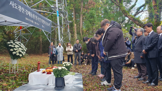 지난해 11월 25일 한국 정부가 일본 니가타현 사도광산 조선인 기숙사 터에서 사도광산 강제동원 한국인 희생자 추도식을 열었다. 한국측 유족과 참석자들이 헌화한 뒤 묵념하고 있다. 연합뉴스