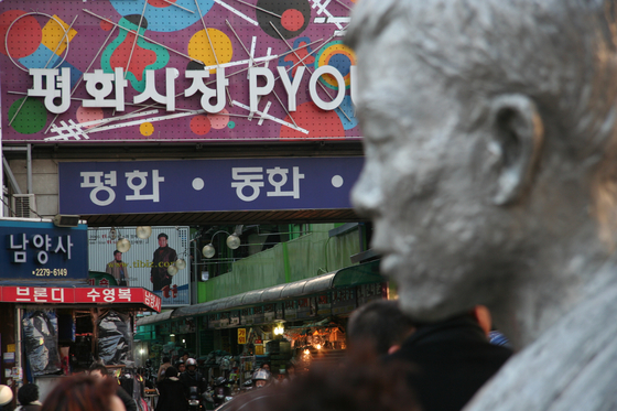 서울 청계천로에 있는 전태일 동상과 평화시장 모습. [사진 전태일기념관, 중앙포토]