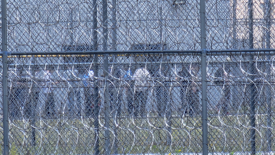현지 시간 6일 미국 조지아주 포크스턴에 위치한 불법 체류자 구금 시설에서 지난 4일 체포된 한국인 근로자 300여명이 30여명씩 그룹을 나눠 추가 조사를 받기 위해 줄을 서 있다. 30도가 넘는 무더위 속에 이들은 푸른색 죄수복 하의를 착용했고, 손에는 서류를 한장씩 들고 있다. 포크스턴=강태화 특파원