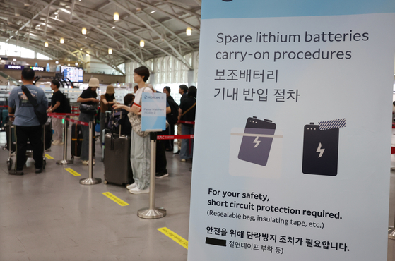 부산 강서구 김해국제공항 대한항공 수속카운터 앞에 보조배터리 기내 반입 절차 안내문이 세워져 있다.   국토교통부는 '보조배터리 기내 안전관리 대책'을 일부 보완해 9월부터 보조배터리 화재 방지용으로 공항에서 제공해 오던 비닐봉지 대신 절연테이프를 제공한다고 밝혔다.연합뉴스