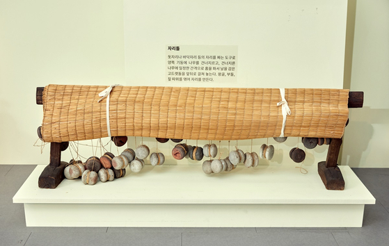 돗자리나 바닥자리 등의 자리를 짜는 도구인 자리틀. 아래 매달린 돌들은 세로축을 고정할 때 쓰는 추다. 