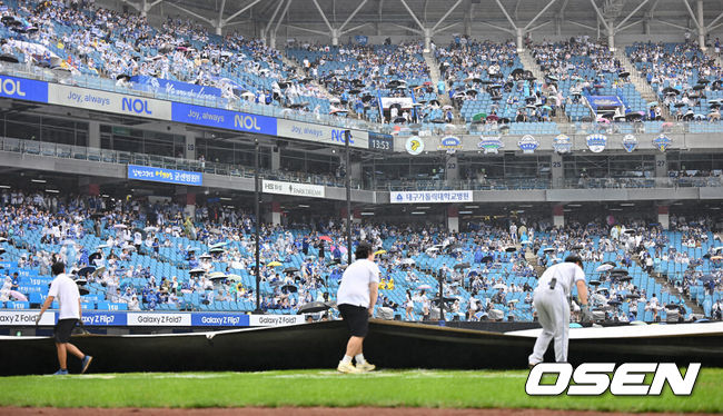 [OSEN=대구, 이석우 기자] 7일 대구 삼성라이온즈파크에서 2025 신한 SOL뱅크 KBO 와일드카드 결정전 삼성 라이온즈와 NC 다이노스의 경기가 열린다. 홈팀 삼성은 로건이 방문팀 NC는 원태인이 선발 투수로 출전한다.갑자기 비가 내리자 관계자들이 방수포를 덮고 있다. 2025.10.07 / foto0307@osen.co.kr