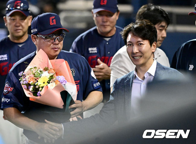[OSEN=잠실, 최규한 기자] 프로야구 롯데 자이언츠가 두산 베어스를 꺾고 3연승을 이어갔다.김태형 롯데 감독은 개인 통산 700승을 달성했다.롯데는 31일 서울 잠실구장에서 열린 2024 KBO리그 두산과 경기에서 7-4로 승리했다. 중심타자 레이예스가 4타수 3안타 3타점으로 활약했고, 전준우는 투런 홈런을 터뜨렸다.경기를 마치고 승리한 롯데 김태형 감독이 박준혁 단장에게 개인 통산 700승 축하 꽃다발을 받고 있다. 2024.08.31 / dreamer@osen.co.kr