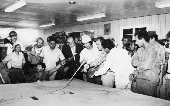 무아마르 카다피 리비아 최고지도자(가운데 두건 쓴 이)가 대수로 공사 모형을 살펴보고 있다. [중앙포토]