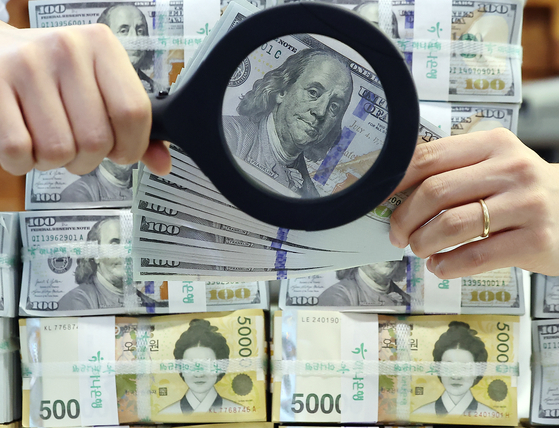 지난 25일 서울 중구 하나은행 위변조대응센터에서 관계자가 원화와 달러화를 정리하는 모습. 뉴스1