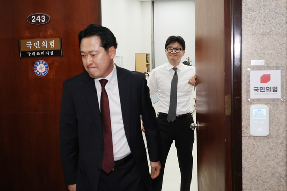 한동훈 당시 국민의힘 대표가 지난해 12월 당대표실에서 장동혁 의원이 나가는 사이 미소를 짓고 있다. 연합뉴스