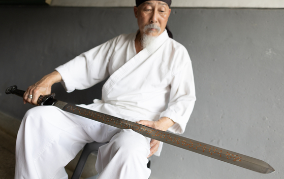경북 문경의 이상선 장인이 1998년 제작한 사인검(四寅劍)을 살펴보는 모습. [사진 강형원]