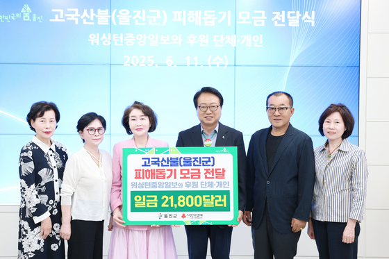 김영천 워싱턴중앙일보 발행인(왼쪽 세번째)이 손병복 울진군수(왼쪽 네번째)에게 고국산불 피해돕기 모금액 2만1800달러를 전달하고 있다. 