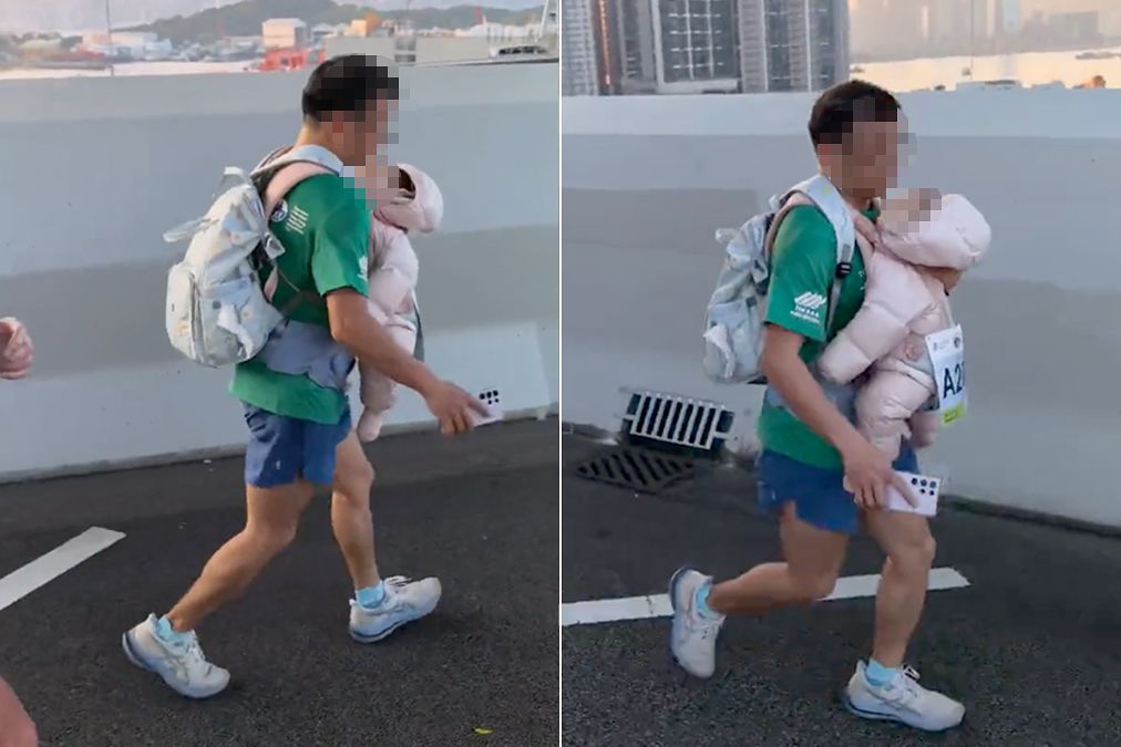지난 21일(현지시간) 홍콩에서 열린 마라톤대회에 아기를 가슴에 안고 달리고 있는 남성 참가자. 사진 유튜브 캡처
