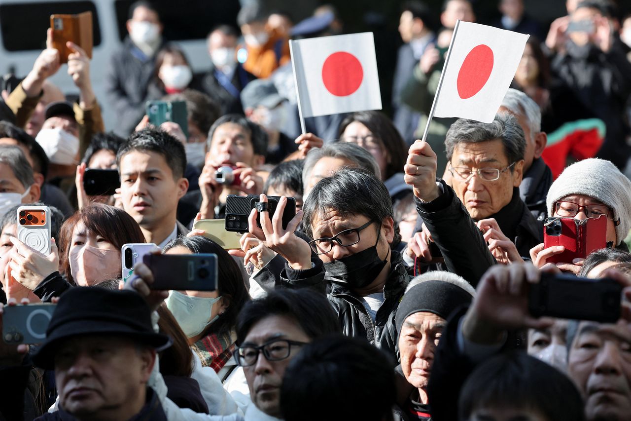 지난 27일 일본 국기를 든 지지자들이 도쿄에서 열린 선거 유세 현장에서 집권 자민당(LDP) 총재이자 총리인 다카이치 사나에의 연설을 기다리고 있다. 로이터=연합뉴스
