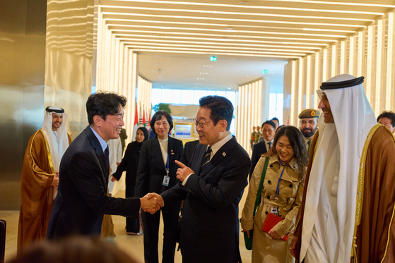 지난해 11월 17일 아랍에미리트(UAE)를 국빈방문한 이재명 대통령이 아부다비 왕실공항에 도착해 미리 도착해 있던 강훈식 비서실장과 만나 악수하고 있다. 파격적 환대를 받은 이 대통령은 "강 실장이 준비를 만이했구만"이라고 말했다고 한다. [사진 청와대]