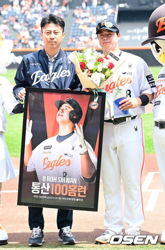 [OSEN=대전, 김성락 기자] 3일 오후 대전 한화생명볼파크에서 ‘2025 신한 SOL Bank KBO리그’ 한화 이글스와 KT 위즈의 경기가 열렸다.이날 홈팀 한화는 폰세, KT는 쿠에바스를 선발로 내세웠다.경기 시작에 앞서 한화 노시환이 손혁 단장에게 역대 108번째 통산 100홈런을 기념 꽃다발을 전달 받은 뒤 기념촬영을 하고 있다. 2025.06.03 / ksl0919@osen.co.kr
