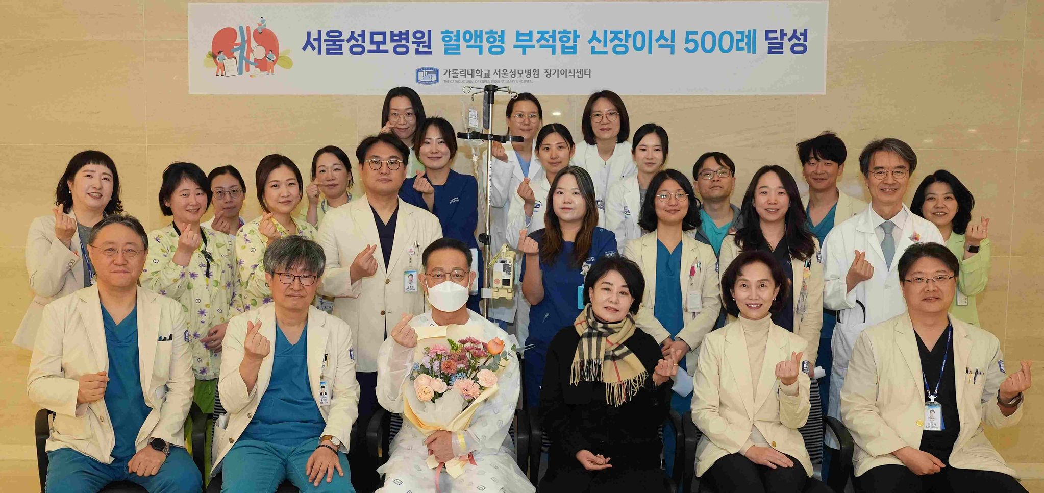 서울성모병원에서 혈액형 부적합 신장이식을 받은 조씨 부부와 병원 의료진이 단체사진을 찍는 모습. 사진 서울성모병원