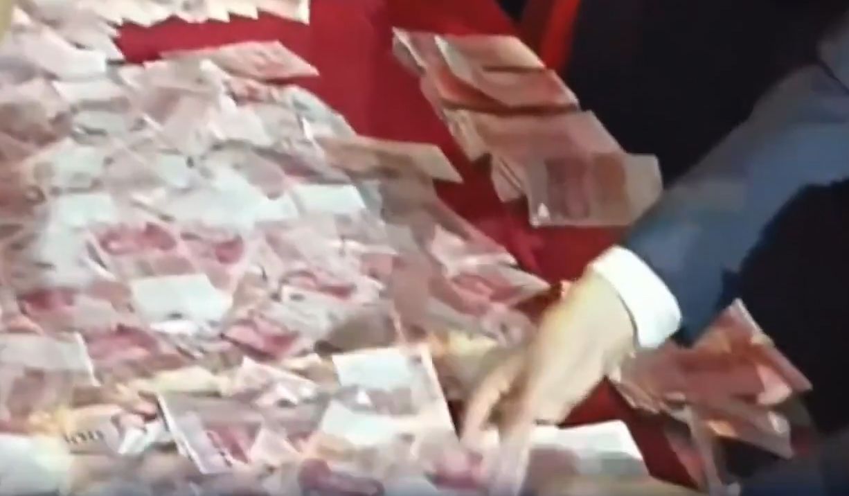 지난 13일(현지시간) 중국 허난성의 한 크레인 제조업체 연례행사에서 직원들이 성과급으로 나온 현금을 세고 있다. 사진 웨이보 캡처