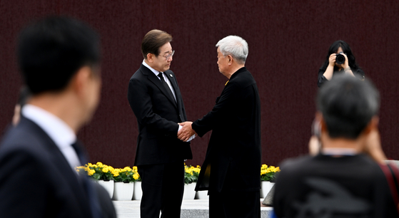 이재명 더불어민주당 대선 후보가 오전 김해시 봉하마을 고 노무현 전 대통령 묘역을 찾아 참배를 마친 뒤 배우 명계남과 인사를 하고 있다. 김성룡 기자