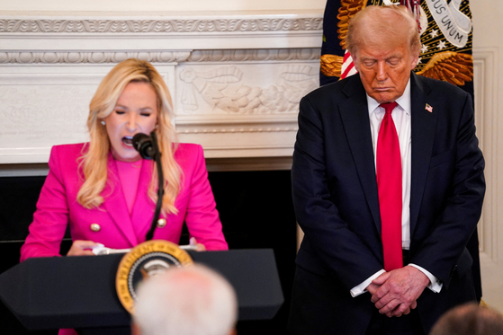 도널드 트럼프 미국 대통령이 지난해 7월 14일(현지시간) 워싱턴 백악관에서 열린 신앙사무국 오찬에서 폴라 화이트 백악관 신앙사무국 선임고문이 인도하는 기도에 동참하고 있다. 로이터=연합뉴스