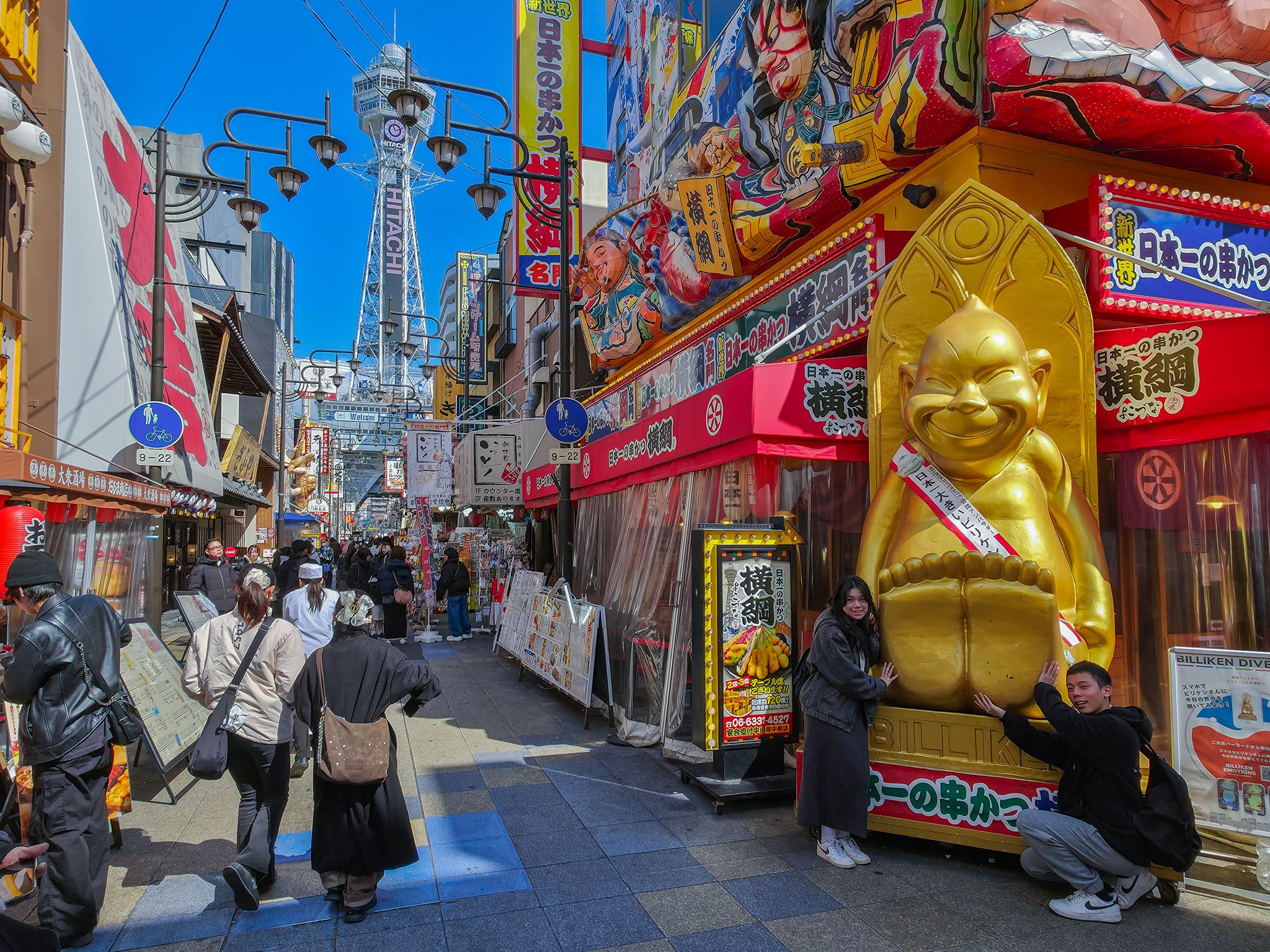 오사카 랜드마크 타워 '츠텐카쿠'와 신세카이의 먹자 골목 풍경. 행운의 신 '빌리켄' 조형물이 포토존 역할을 한다. 백종현 기자 