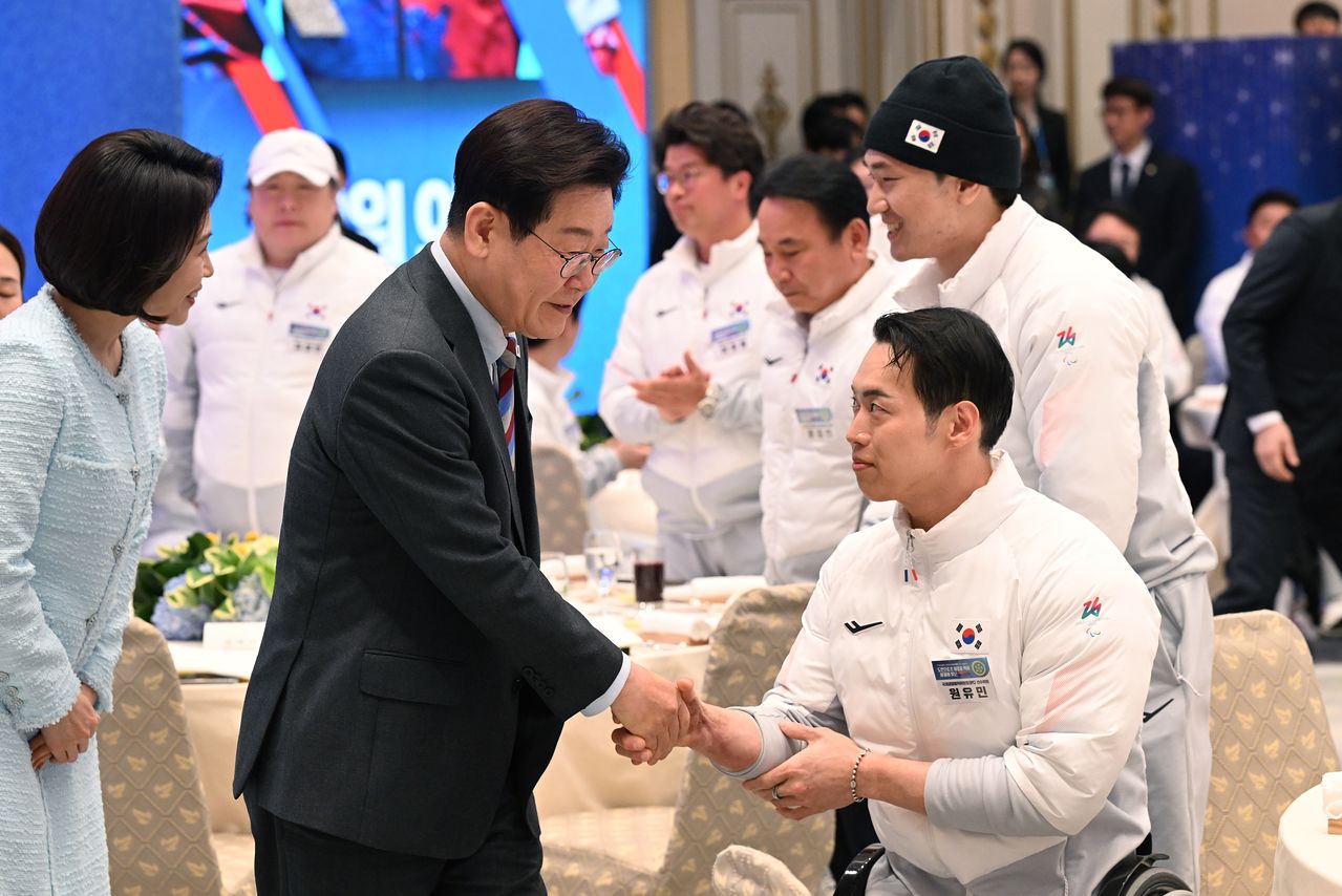  이재명 대통령과 김혜경 여사가 20일 청와대에서 열린 밀라노-코르티나 동계 패럴림픽 선수단 격려 오찬에서 참석한 선수들과 인사를 나누고 있다. [청와대사진기자단]