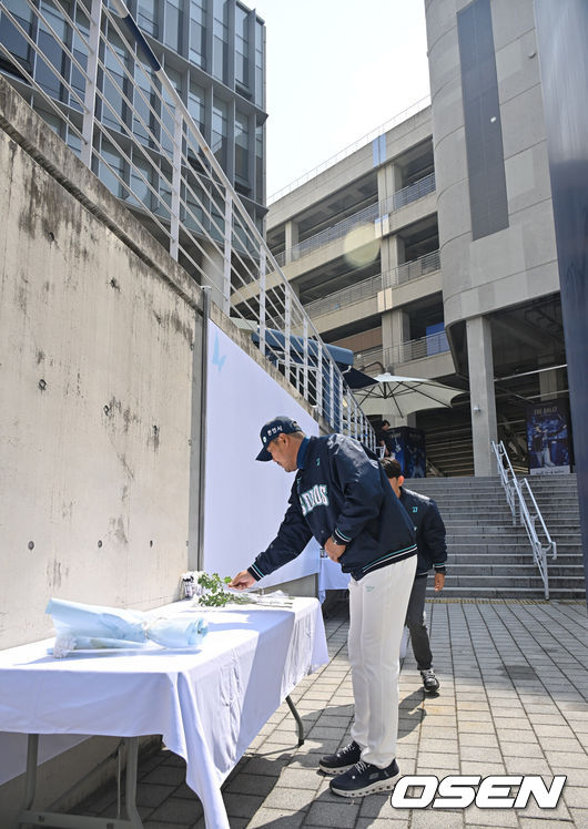 [OSEN=창원, 이석우 기자] 29일 창원NC파크에서 2026 신한 SOL KBO 리그 NC 다이노스와 두산 베어스의 경기가 열린다. NC 다이노스 야구단이 1년전 창원NC파크 외벽 구조물 추락 사망 사고 1주기 추모행사를 열었다. NC 다이노스 이호준 감독이 희생자의 명복을 빌며 헌화하고 있다. 2026.03.29 / foto0307@osen.co.kr