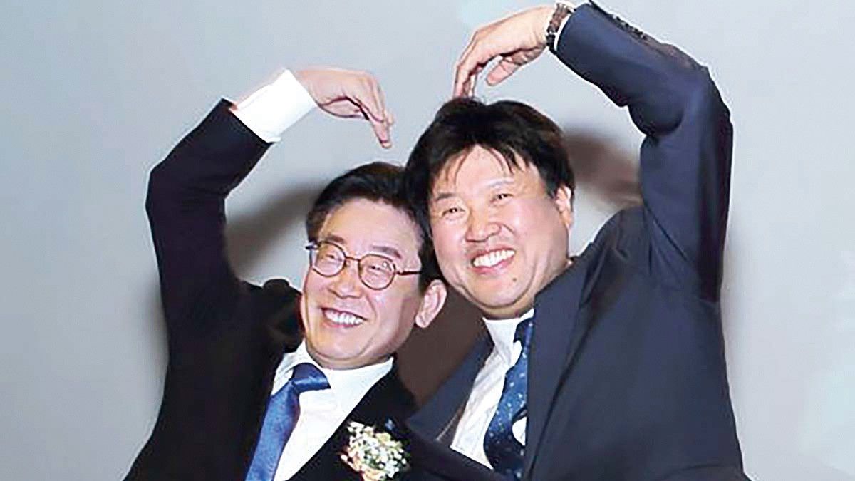 2019년 12월 이재명 당시 경기도지사와 김용 전 대변인이 ‘김용의 북콘서트’에 참석해 손 하트를 하며 사진을 찍고 있다. 이 대표는 이날 축사를 하며 “김용 전 대변인은 뜻을 함께하는 벗이자 제 분신 같은 사람”이라고 소개했다. [사진 김용 전 민주연구원 부원장 블로그 캡처]