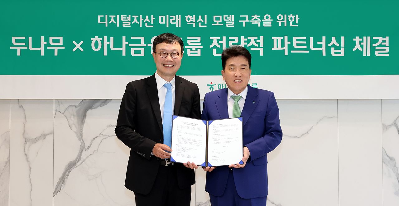 하나금융그룹은 15일 주요 관계사인 하나은행을 통해 국내 최대 가상자산 인프라를 보유한 ‘두나무’에 대한 1조원 규모 지분을 취득하고, 금융과 디지털자산을 연계한 미래혁신모델 구축을 위한 전략적 업무협약을 체결했다. 이날 협약식에 참석한 함영주 하나금융그룹 회장(사진 오른쪽)이 김형년 두나무 부회장(사진 왼쪽)과 함께 협약서를 들고 기념촬영을 하고 있다. 하나금융 