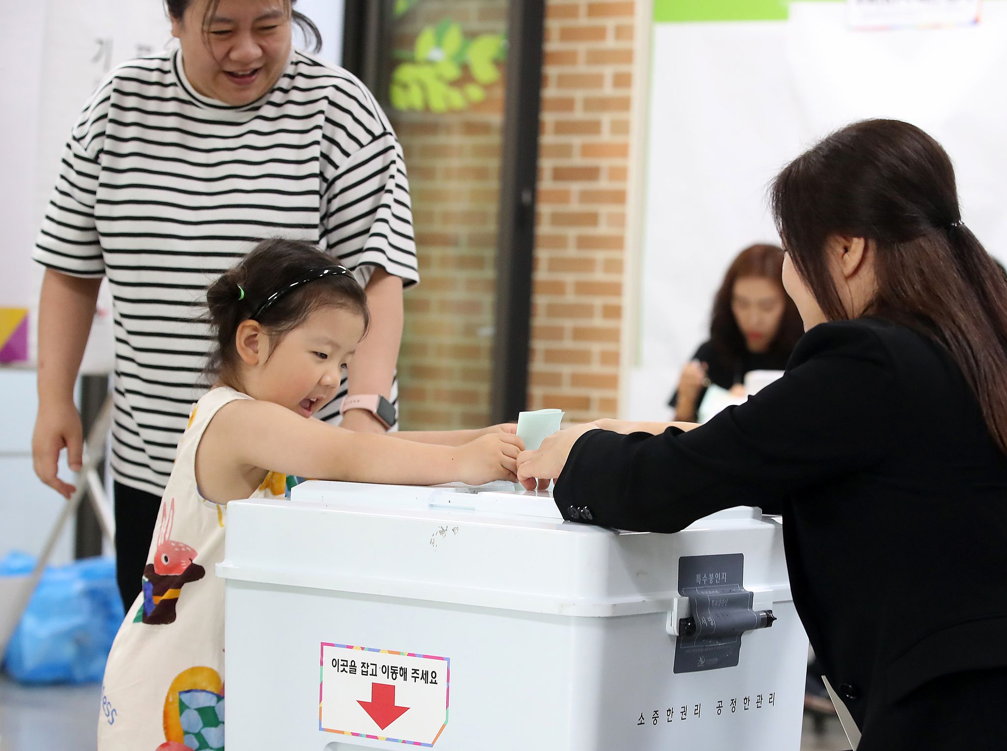제9회 전국동시지방선거일인 3일 오전 대구의 한 투표소에서 엄마를 따라 온 어린이가 투표함에 투표지를 넣고 있다. 뉴스1