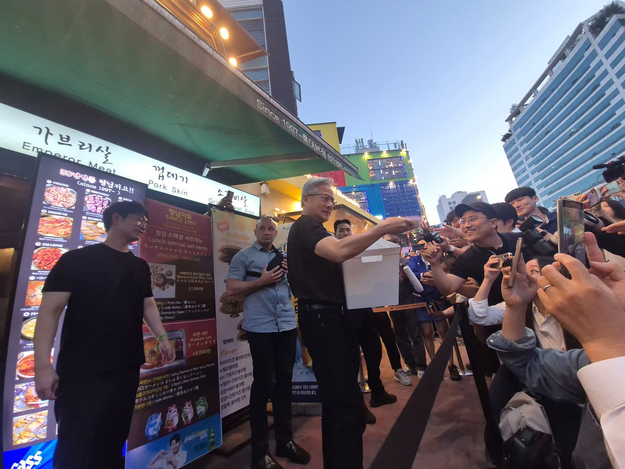 5일 서울 마포구의 한 고깃집 앞에서 젠슨 황 엔비디아 CEO가 고대역폭메모리(HBM) 과자를 나눠주고 있다. 이우림 기자