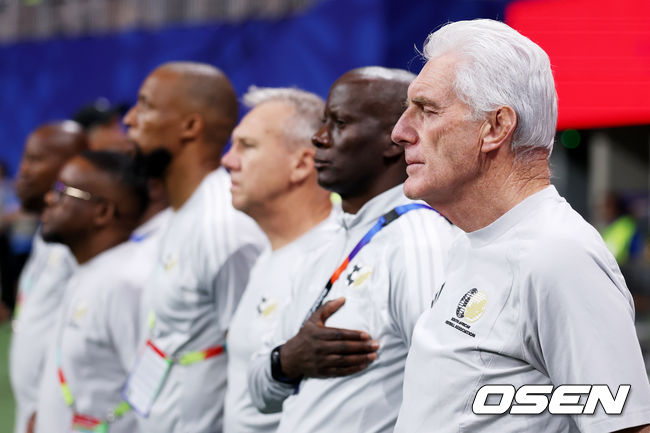 ATLANTA, GEORGIA - JUNE 18: Hugo Broos, Head Coach of South Africa, stands for the national anthem before the FIFA World Cup 2026 Group A match between Czechia and South Africa at Atlanta Stadium on June 18, 2026 in Atlanta, Georgia. (Photo by Lars Baron/Getty Images)