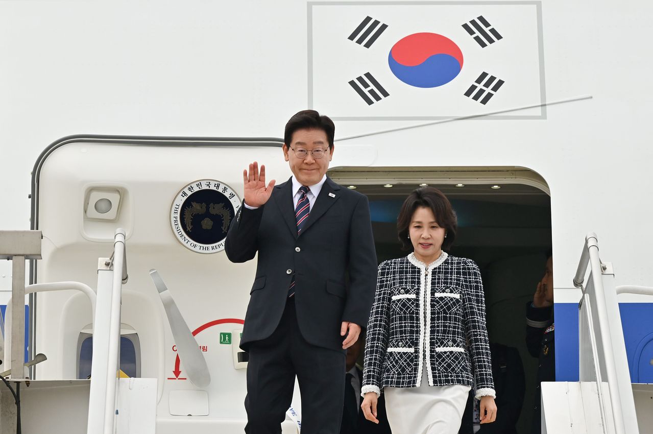  이재명 대통령과 김혜경 여사가 29일(현지시간) 칠레 산티아고 아르투로 메리노 베니테스 공항에 도착해 인사하고 있다. 뉴스1