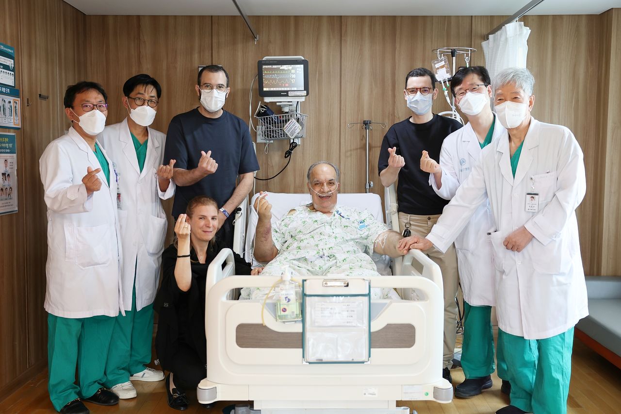 모로코 삼부자 가족이 2대1 생체간이식 수술을 집도한 서울아산병원 간이식·간담도외과 의료진과 기념촬영을 하고 있다. 왼쪽 첫 번째부터 문덕복·송기원 교수, 기증자인 첫째 아들 하침 씨, 수혜자의 아내, 수혜자 모하메드 씨, 기증자인 둘째 아들 오마르 씨, 정동환 교수·이승규 석좌교수.