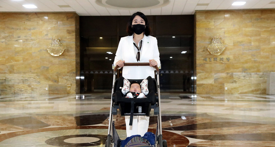 용혜인 성평등부 장관 후보자가 지난 2021년 출산 2개월여 만에 아이와 함께 국회에 출근해 본회의장을 지나고 있다. 임현동 기자
