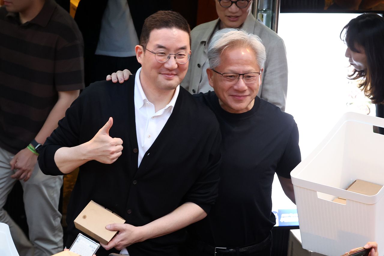 젠슨 황 엔비디아 최고경영자(CEO)가 지난 6월 서울 마포구 홍대 인근의 한 고깃집에서 구광모 LG그룹 회장의 어깨에 손을 올린 채 시민들과 소통하고 있다. 뉴시스