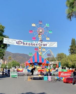Volunteers set up Oktoberfest before the masses of people arrived. The ride “Rampage” is seen behind the official poster. [Source: Author, Hannah Sung]