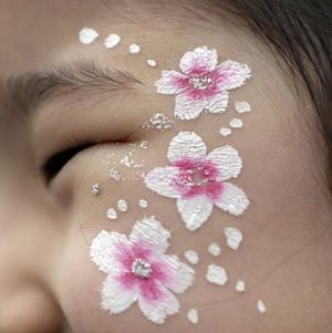 In celebration of spring and cherry blossoms, many festivals include face painting for children. [Source: Associated Press, Lee Jin Man] 