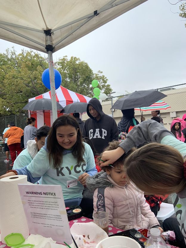 Highschool volunteers at the face painting booth.  [Source: Author, Hannah Sung]