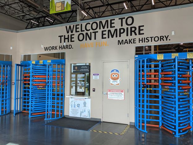 At the front security checkpoint, a board says “Work Hard. Have Fun. Make History.” 