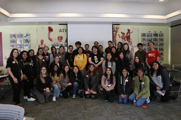 The students and journalists pose for a group picture.