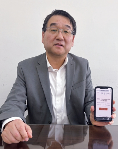 장병희 사람북 대표가 휴대전화로 ‘미니 자서전 프리미엄 클래스’ 웹사이트를 소개하고 있다. 